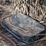 This woman found an old and dirty suitcase, abandoned in a bush
